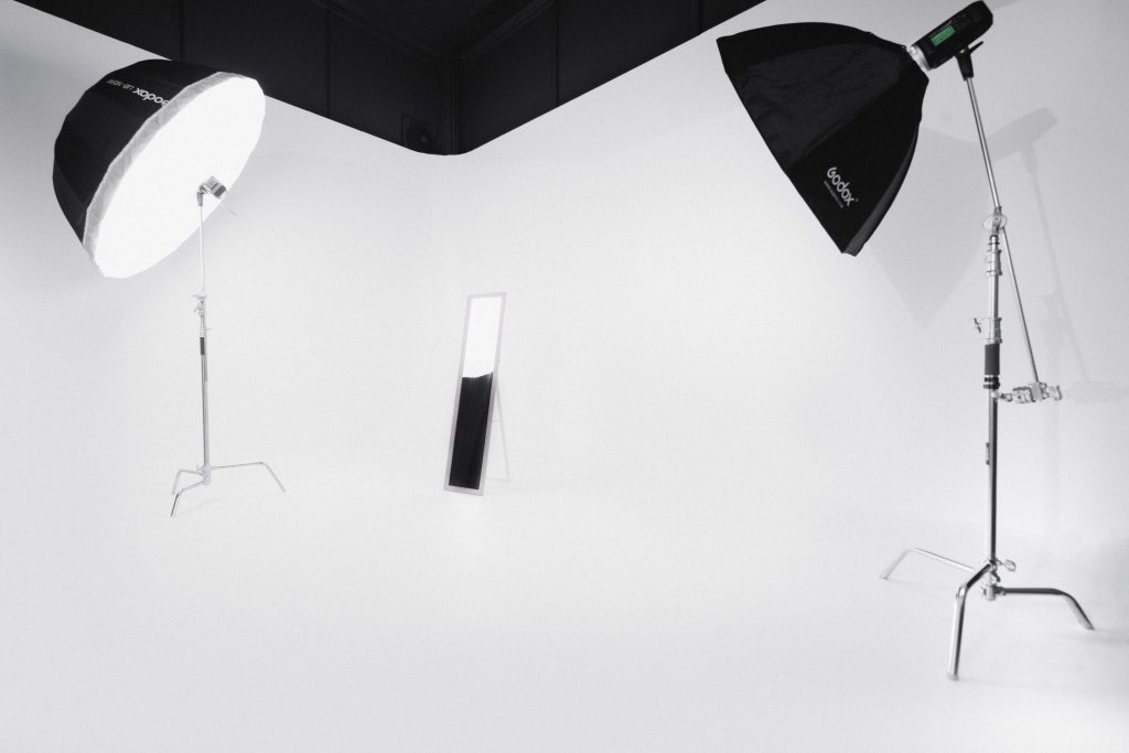 photography studio space with two tripods and two studio lights on them