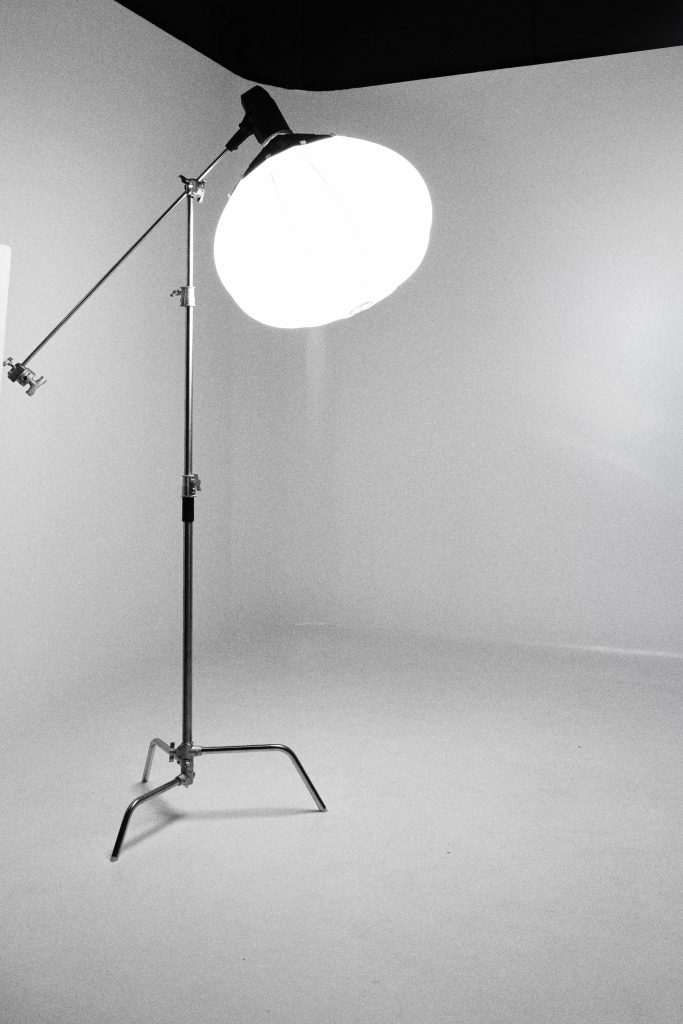 photography studio space with one tripod and two studio light it